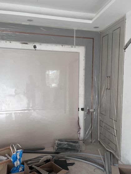 A glimpse of the raw, unfiltered reality of an interior design project. This photo from a site in Saket shows the space during the construction phase, with materials and tools ready for the transformation.