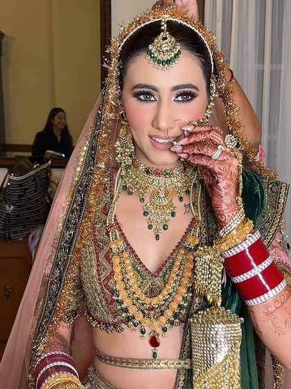 A playful and coy moment, showing off the beautiful makeup and intricate jewelry.