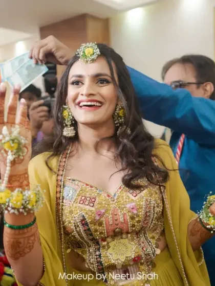 A candid moment from a Haldi ceremony. The bride's genuine smile is the best accessory to her minimal makeup and floral jewelry.
