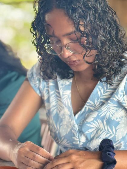 A candid shot of a participant working on her project. Our goal is to create a culture where ideas spark and stories bloom face-to-face.