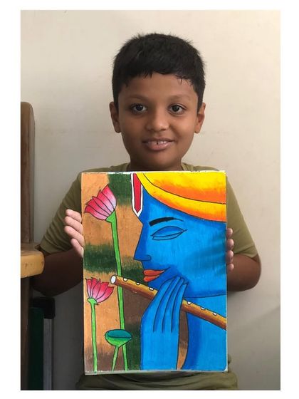 Another student with his equally beautiful painting of Lord Krishna, showing how different artists can bring their own energy to the same divine subject.