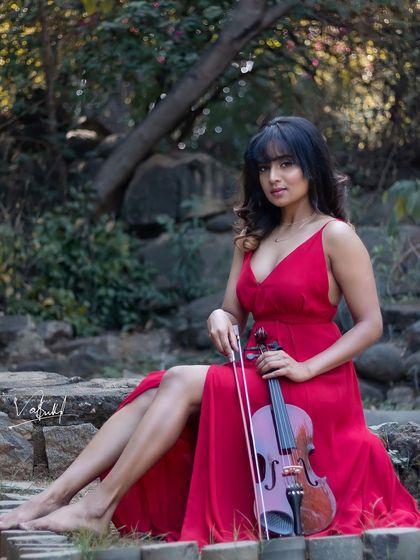 A picture painted in a dream and captured through the camera. This conceptual shoot combines the elegance of a flowing red dress and a violin with a rustic, natural setting for a truly artistic portrait.