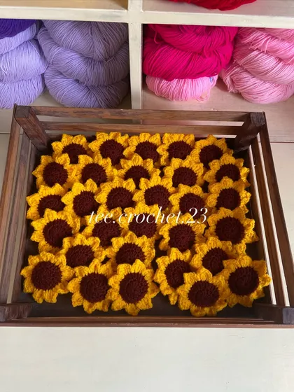 A crate full of sunflower heads, which can also be used as appliques or keychains.
