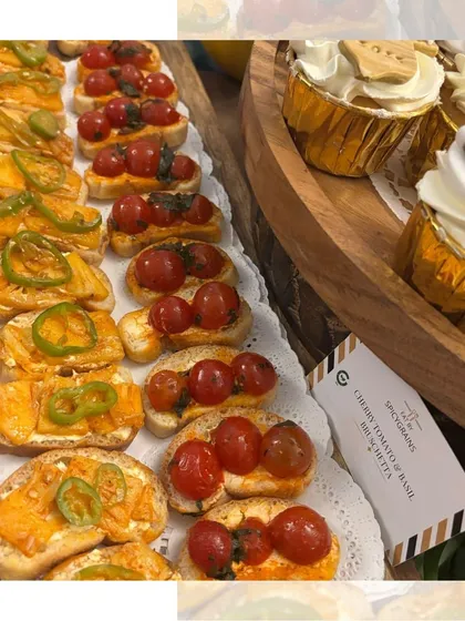 A platter of assorted bruschetta, featuring classic cherry tomato and basil alongside a spicy bell pepper topping. It's a simple, fresh, and colorful appetizer for any occasion.