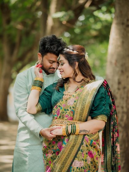 An intimate portrait where the bride gently touches her groom's face. Their soft expressions and close embrace create a deeply romantic and emotional photo.