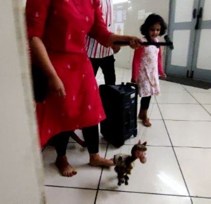 A little girl follows along as one of our team members demonstrates how to operate a small horse marionette. Learning through play is at the core of what we do.