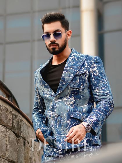 For the man who isn't afraid of bold patterns, this custom-printed denim suit features a unique blue and white splatter design. It’s a statement of individuality and high-fashion edge.