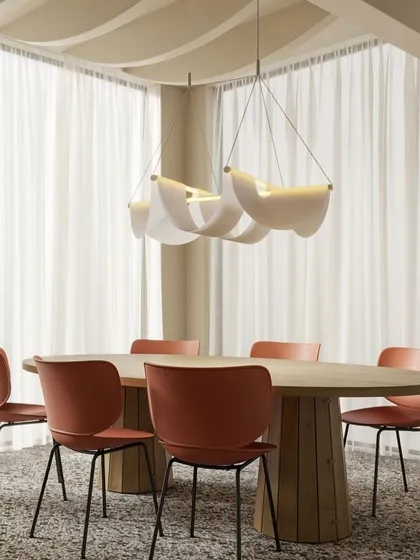 The Drape Light by Jamie Wolfond for Moooi showcases elegance through simplicity. Like a piece of fine fabric, its shade is gracefully suspended to create a soft, downward glow, perfect for bringing a sense of warmth and effortless style to a dining area.
