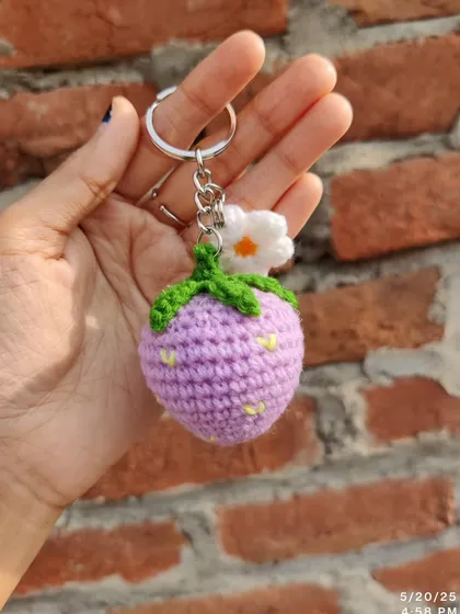 Sweet strawberry and daisy keychains. These come in red, pink, and purple, each with a little white flower.