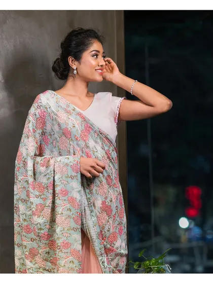 This flamingo pink saree is a beautiful blend of printed georgette and elegant net. The half and half design creates a contemporary and graceful look.