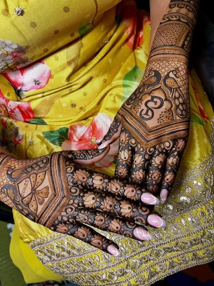 Another angle of this exceptional bridal design, showing the consistency and clarity of the peacock and lotus motifs across both hands.