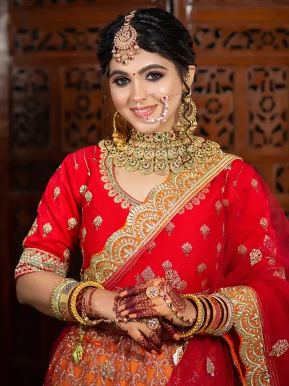 A classic bridal look for a client in a red and orange lehenga. The makeup is kept clean and radiant to let the outfit shine.