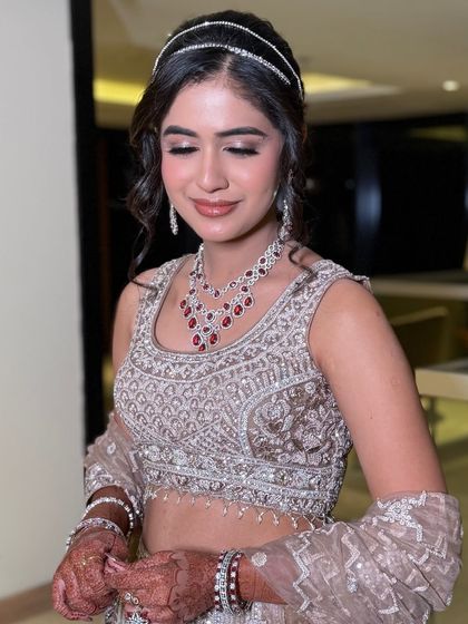 A close-up of the sangeet look, showcasing the soft smokey eye and the beautiful rosy lip color.