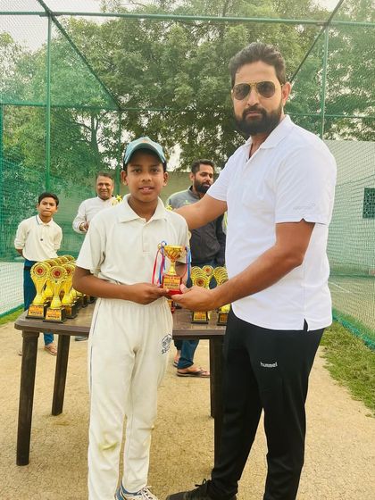 A young player receiving his trophy after a great performance.