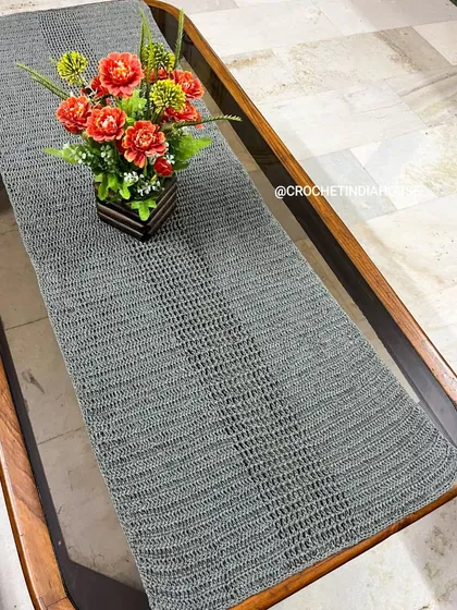 Another angle of the crochet table runner, showing its clean lines and beautiful drape. It's a versatile piece that can be used for daily dining or special occasions.
