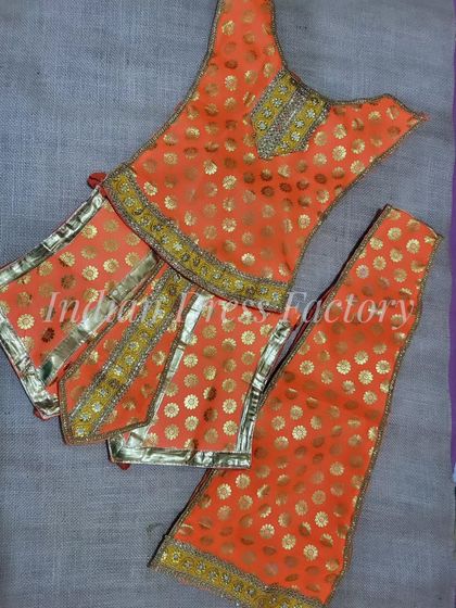 A bright orange brocade outfit with gold buti work, specially designed and stitched for a Hanuman ji idol.