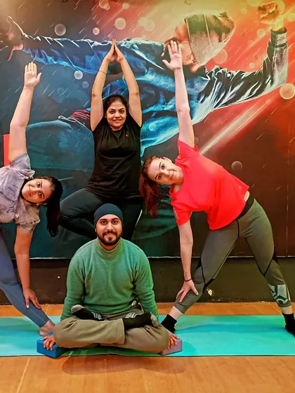 A fun group pose combining a seated posture with standing balances. We love to get creative and celebrate our practice together.