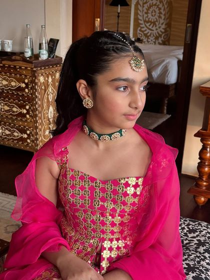 A beautiful portrait of the young client, showcasing her braided ponytail and traditional Indian jewelry.