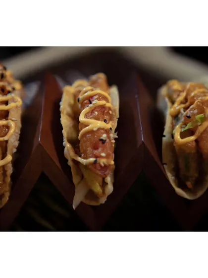 A close-up of the Korean Avocado Tacos, showing the sesame seed garnish that adds a nutty flavor to this unique fusion dish.