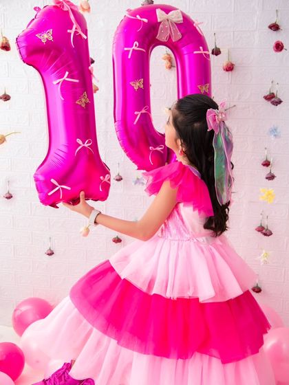 A creative shot for a 10th birthday. Using the number balloons as a prop adds a fun and personal touch to the photos.
