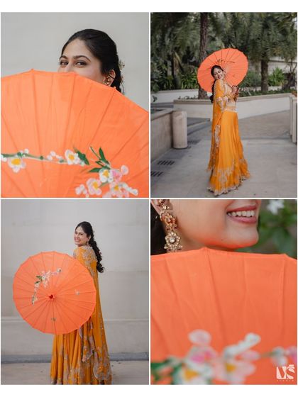 A playful and colourful portrait of the bride with a bright orange umbrella. This shot from Rashi's Mehendi is full of personality and charm, capturing her happy spirit.