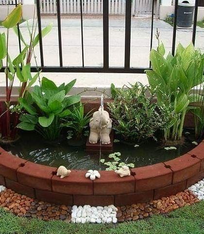 I can create beautiful water features for ground-level gardens too. This small, custom-built pond is bordered with brick and pebbles, featuring an elephant fountain and aquatic plants to create a lively natural ecosystem.