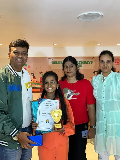 Another successful student, Saiee, proudly displays her certificate and trophy for completing the 3rd level of our abacus course.