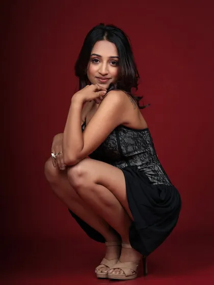 A confident and alluring pose in a black lace dress. This full-body crouch is a dynamic addition to a fashion portfolio.