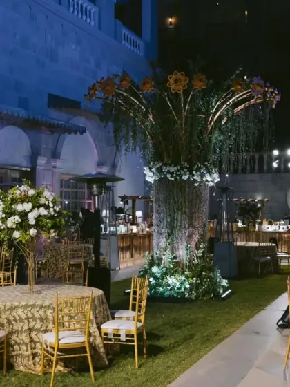 An outdoor lounge area for a Sangeet, featuring a grand floral centerpiece and an elephant ice sculpture. I design spaces that are both functional and visually spectacular.