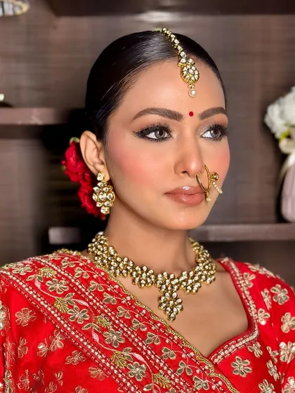 The classic Indian bride is timeless. This look features soft, defined eyes, a radiant complexion, and a bold red lip, creating an elegant and traditional bridal style that will never fade.