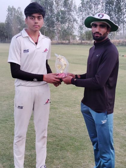 A player receiving a trophy for his standout performance during the last month of the season. Finishing strong is a sign of a true champion.