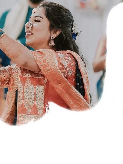 A joyful, candid shot of the bride-to-be dancing during her engagement celebration.