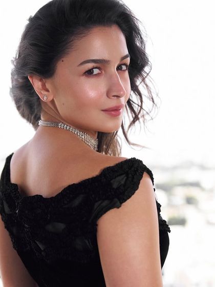 A classic and elegant look for Alia Bhatt. Her hair is styled in a soft, romantic updo that highlights her features, paired with our nail services for a polished finish.