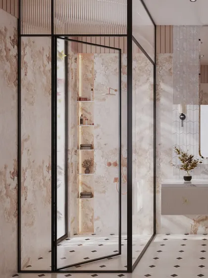 The walk-in shower is enclosed by a black-framed glass partition, adding a modern contrast to the soft, feminine materials. Inside, illuminated niches provide elegant storage for bath essentials.