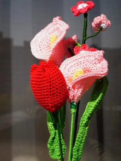 Another view of the crochet lily and tulip bouquet, showing the fine details and vibrant colors that make these flowers so special.