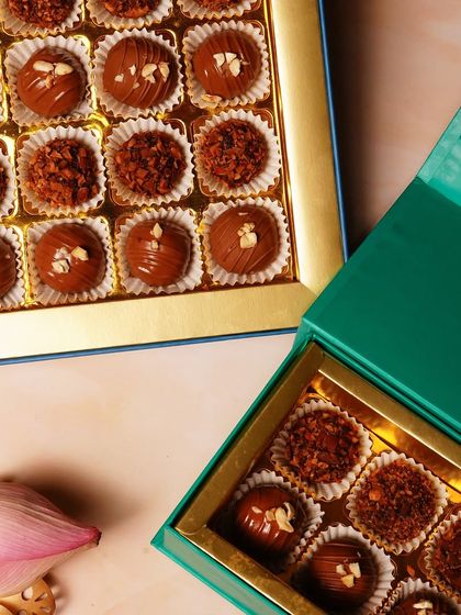 A close-up of the different textures and toppings on our chocolate truffles, from crunchy nuts to smooth cocoa powder.