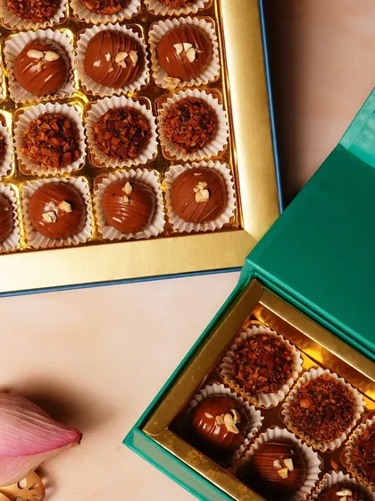 A close-up of the different textures and toppings on our chocolate truffles, from crunchy nuts to smooth cocoa powder.