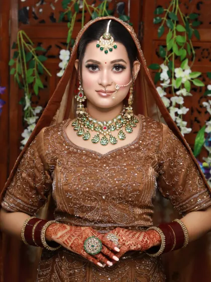 A full portrait of the bride in the bronze-gold lehenga, looking regal and confident.