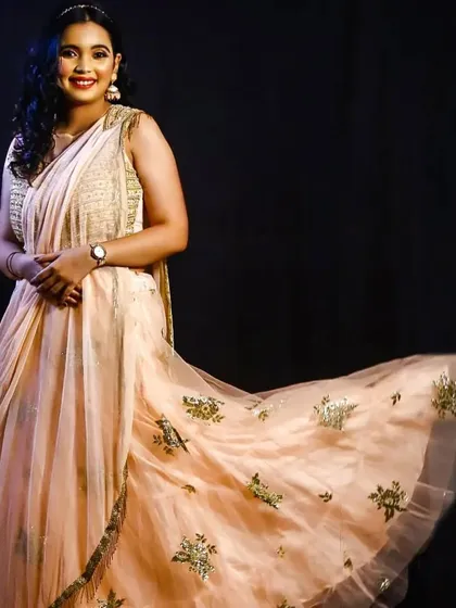 This peach Indo-western lehenga-saree is light, flowy, and elegant. It's a great choice for an engagement or daytime party.