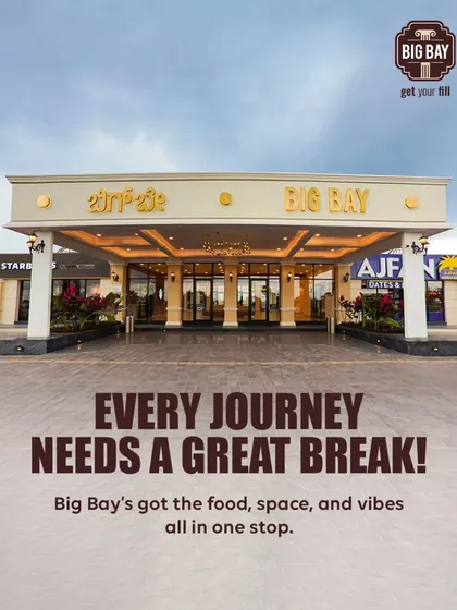 A beautiful daytime shot of our grand entrance, promising that every journey needs a great break, and we've got the food, space, and vibes to provide it.