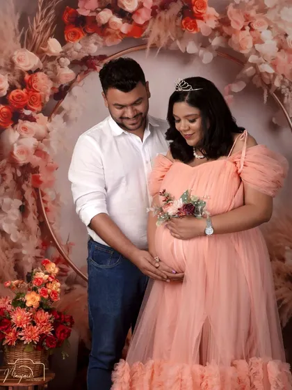 Another beautiful shot of the couple, their hands joined over the baby bump, symbolizing their shared journey into parenthood.