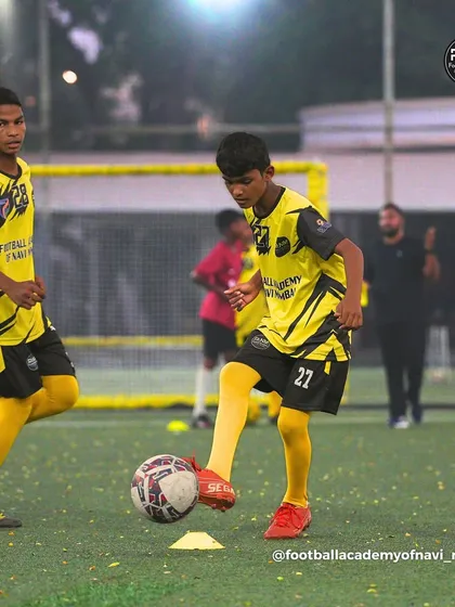 A player practices a technical drill, tapping the ball between his feet to improve his touch.
