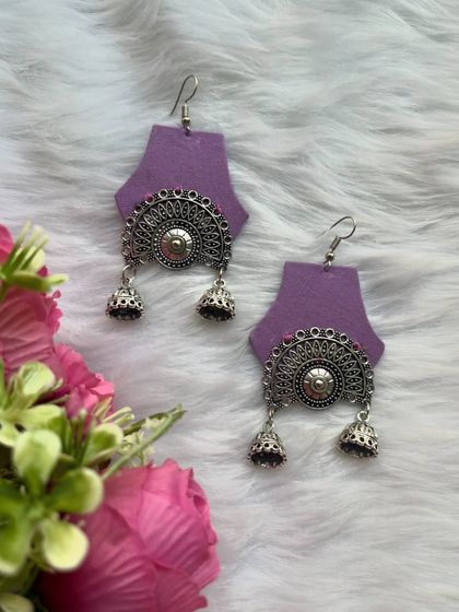 These purple fabric earrings with an oxidised silver chandbali-style charm and jhumkas are a perfect blend of modern and traditional.