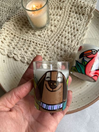 A close-up of the cute dog-themed candle, a great gift for a pet lover.