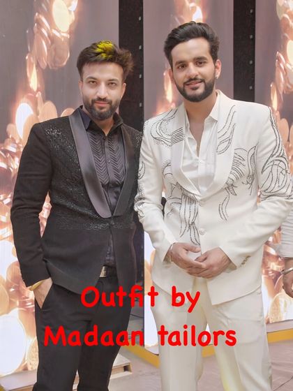 A closer look at the custom white suit with abstract black embroidery, designed for a television appearance. This highlights our ability to create camera-ready formal wear.