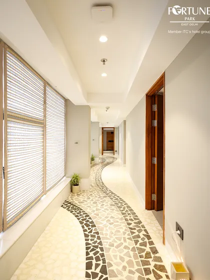 Your journey to tranquility begins the moment you walk down this hallway. The winding mosaic path is designed to lead you away from the city's noise and into the calm of my Iyasya Spa.