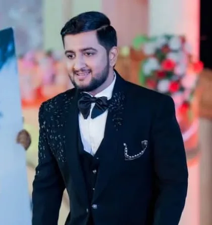 A confident groom ready for his reception. The side-part hairstyle and clean makeup create a classic and timeless party look.