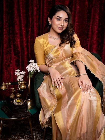 A full portrait of Shruti in a beautiful organza saree. The makeup is kept elegant and minimal to complement the classic, vintage-inspired setting.