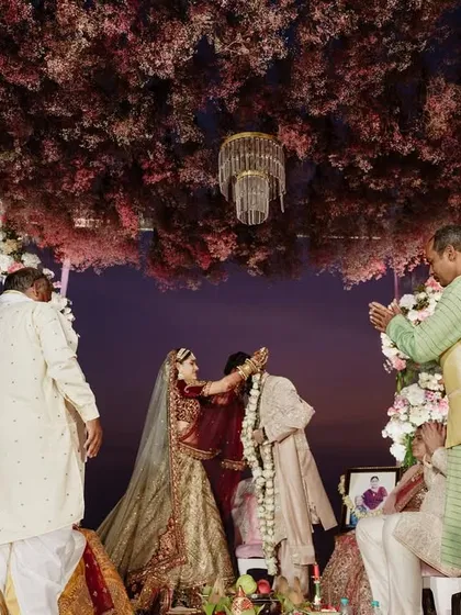 A candid moment during the Varmala exchange under a canopy of flowers. My team and I ensure that while the setting is grand, the ceremony itself feels personal and heartfelt.