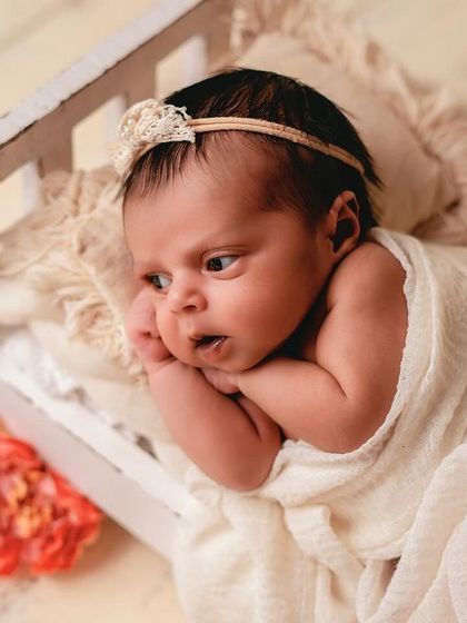 This tiny, rustic bed prop is a client favorite. It's perfect for capturing both sleeping and awake shots, like this one of a curious baby looking off to the side.